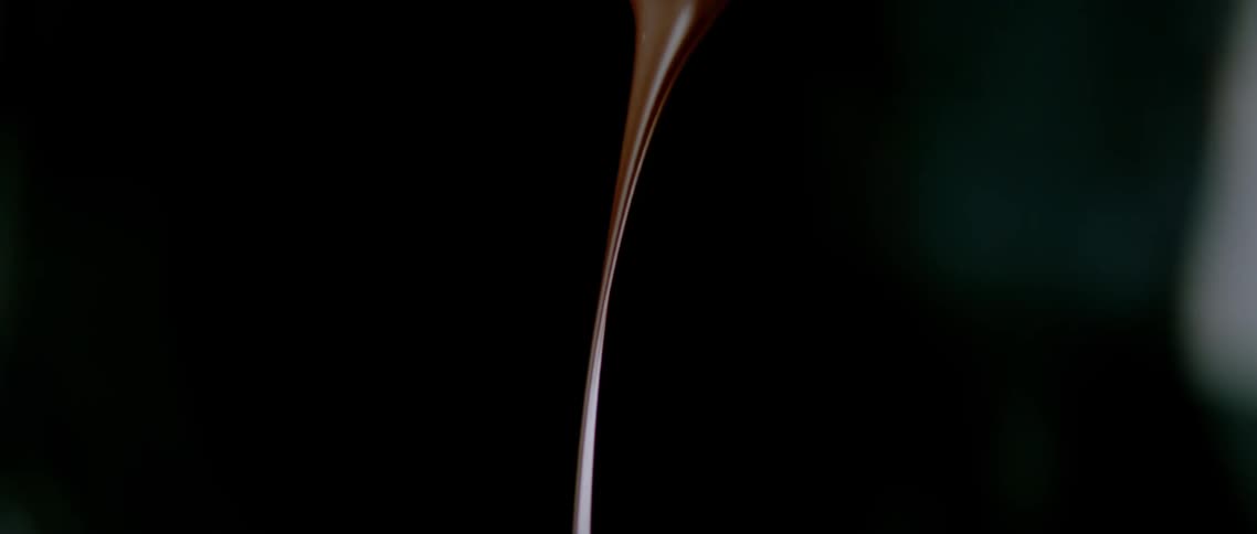 Melted chocolate falling in slow motion