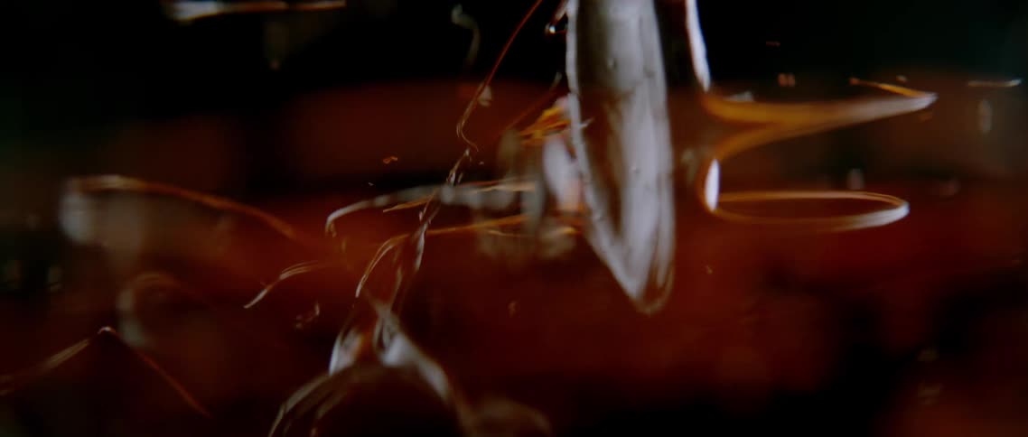 Extreme closeup of a spatula spinning with chocolate