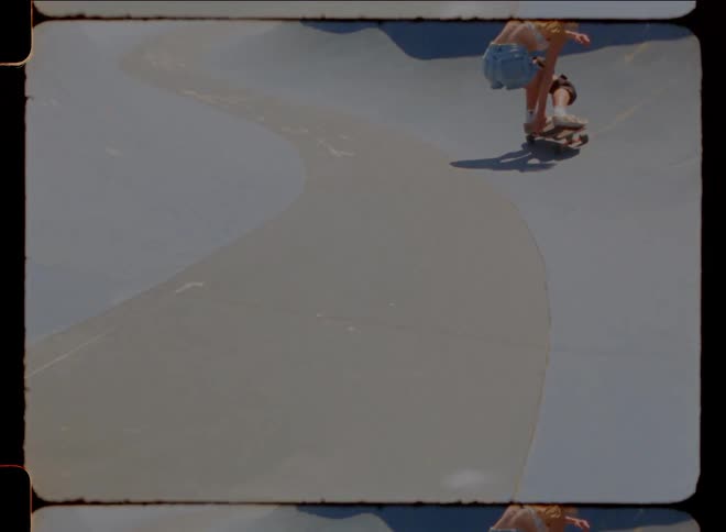 Woman skateboarding on a ramp with her back turned