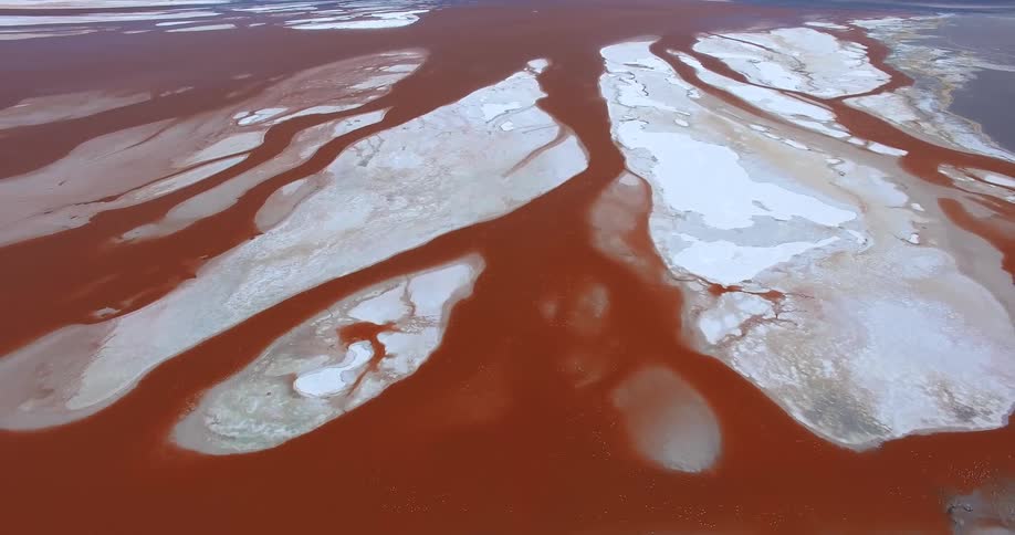 Aerial panorama of a red and white sea of salt