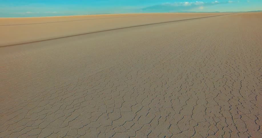 View of dry and desertic ground with a blue sky