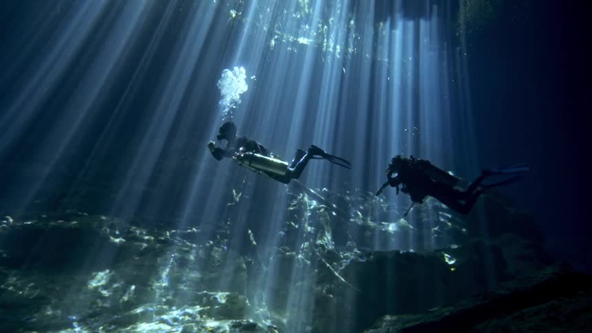 Panorama from inside the sea with two divers exploring