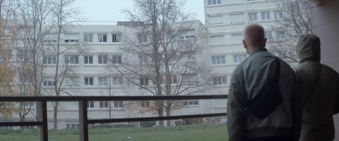 Two people observing apartment blocks