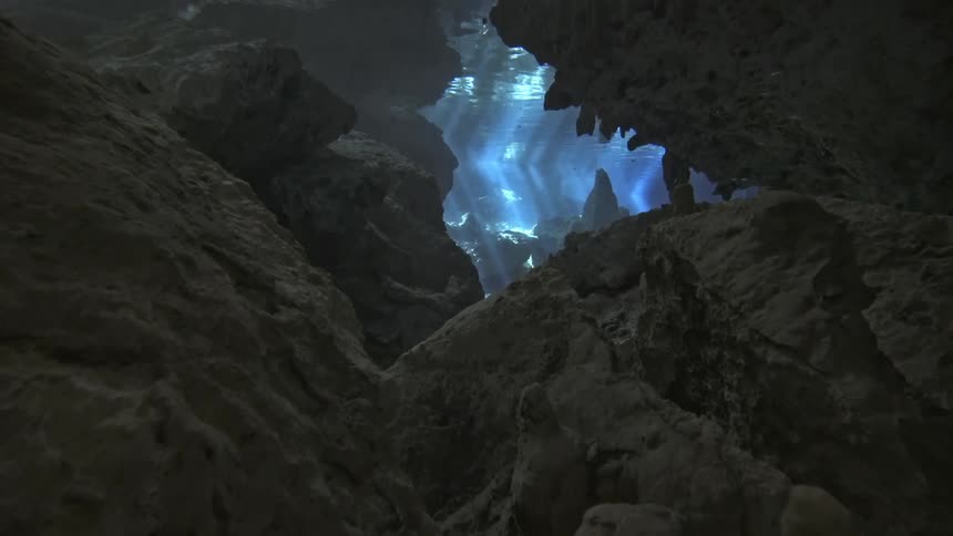 View from inside the sea of a cave with reflections of sunlight