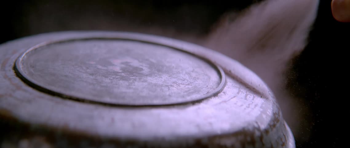 A steel can is being spray painted