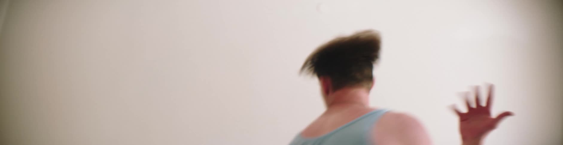 Man wearing an underwear dancing aggressively indoor