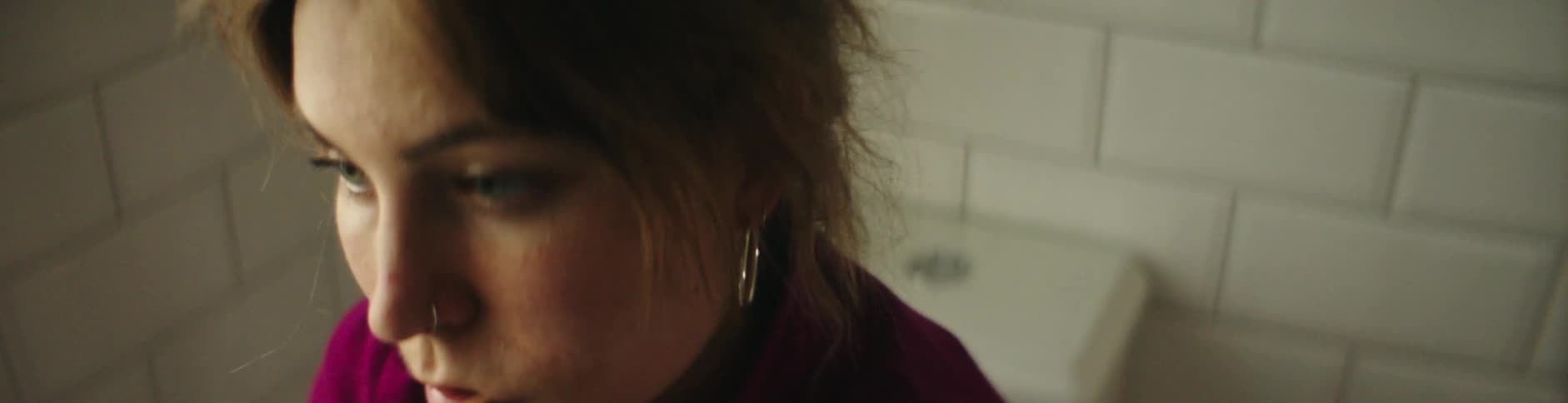 Lady brushing inside the bathroom
