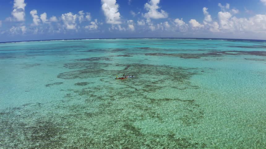 A boat sailing in a clear ocean water