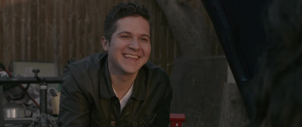 A man smiles looking towards someone