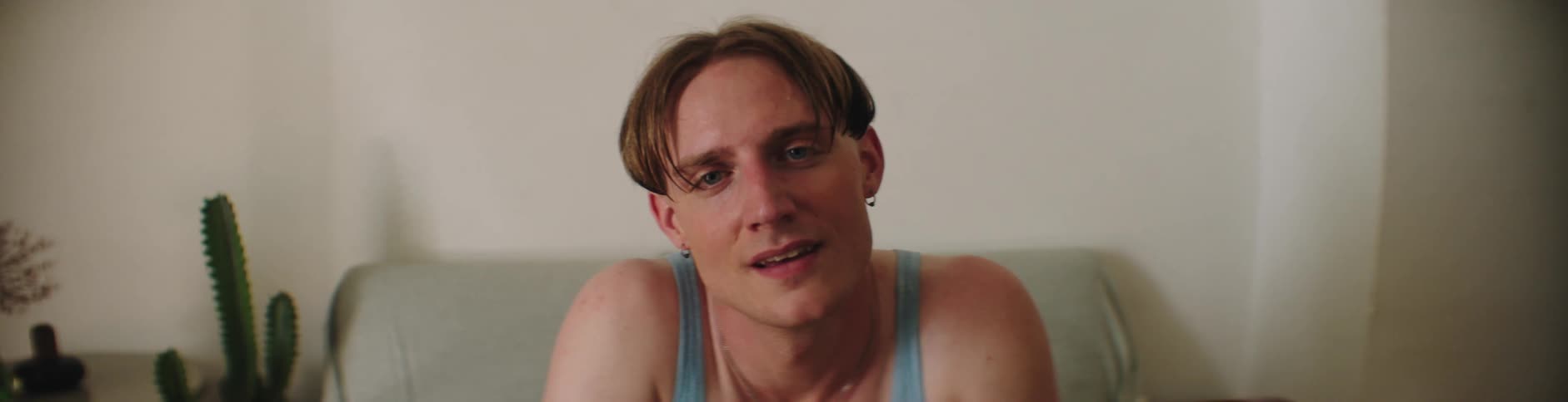 A man is sitting and smiling