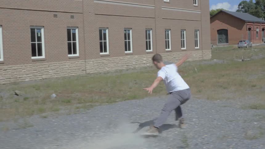 A man is running through a lot dancing