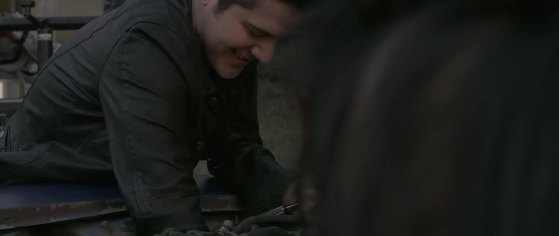 A man is working on a car engine
