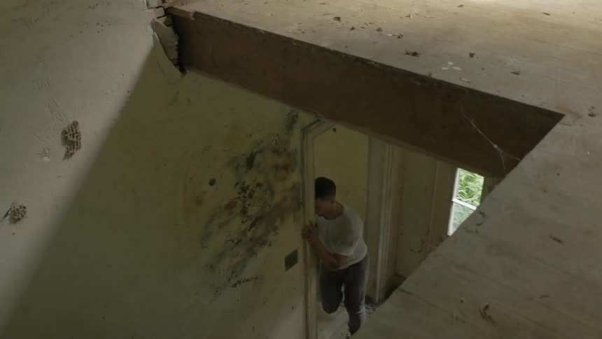 A man is dancing in a home jumping around