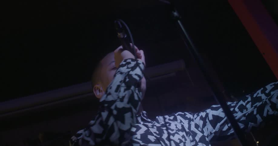 A man sings on stage