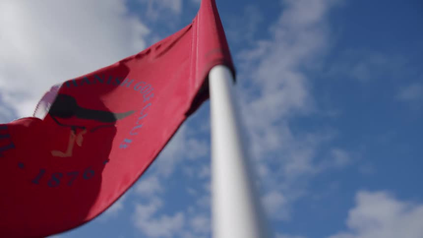 The torn flag flies in the wind