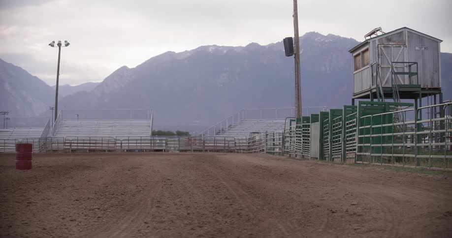 A dirt arena surrounded by green railings