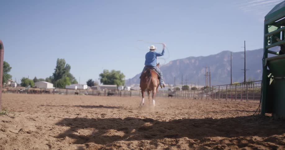 Men riding horses at a rodeo