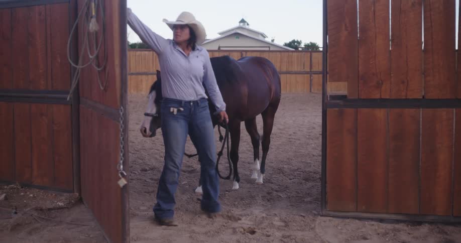 A woman closes the door of the fence