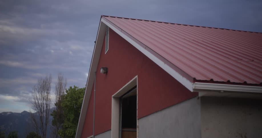 The roof of a house with red and gray paint