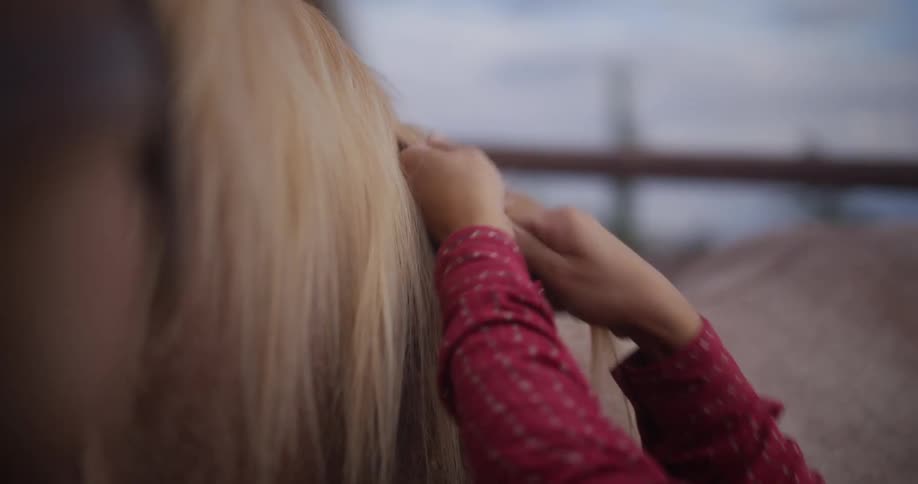 Woman braiding the hair of the horse
