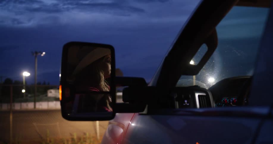 Cowgirl drives a truck to the rodeo