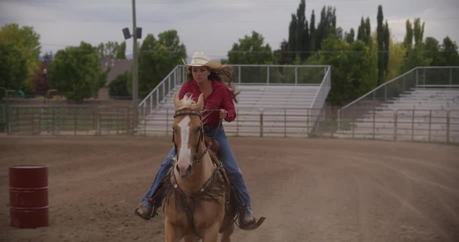Woman riding a horse in a rodeo arena