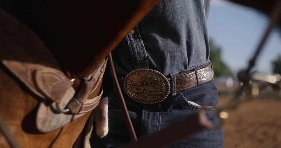 A man is standing by his horse