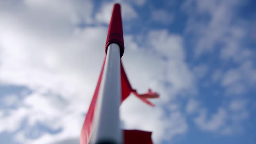 A red flag is swaying with the wind