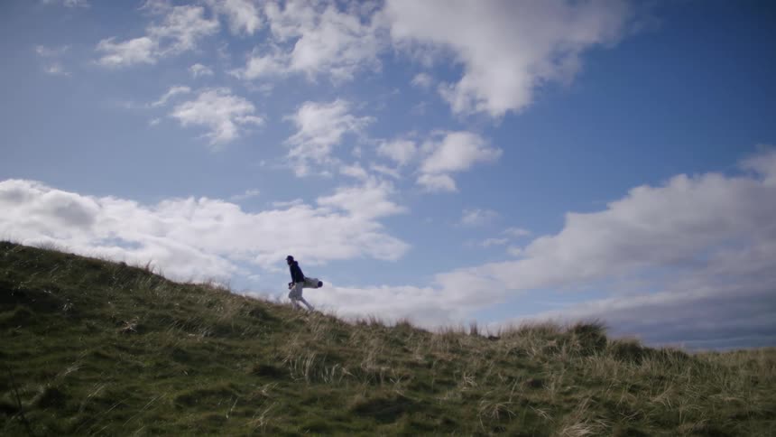 Man climbing a hill at daytime