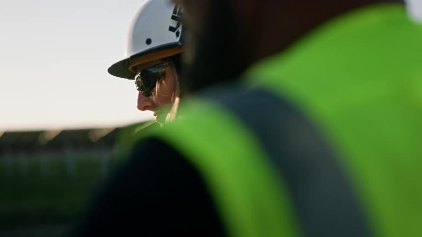 Construction workers inspecting machinery