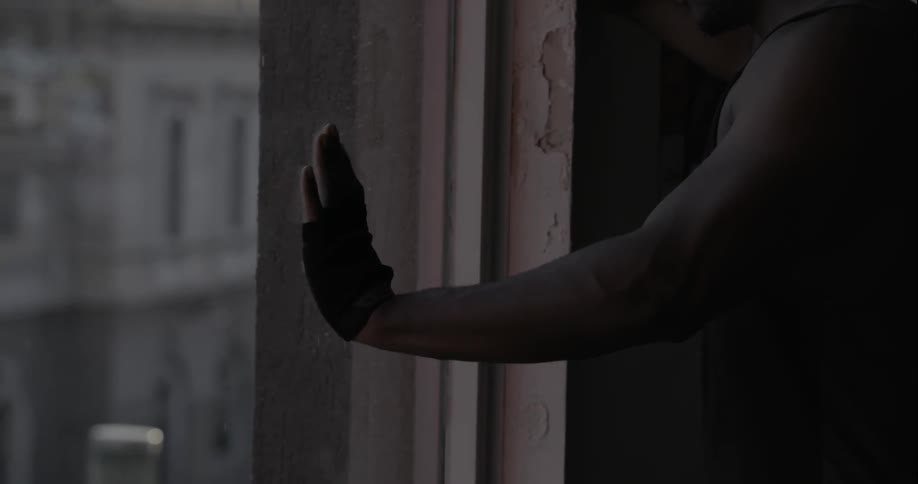 Man looking out his window into the city