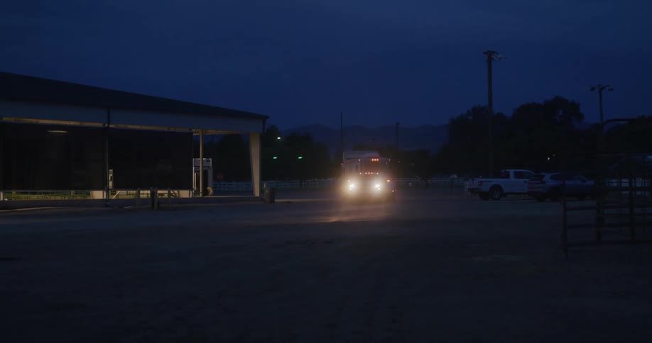 Truck towing a trailer at night