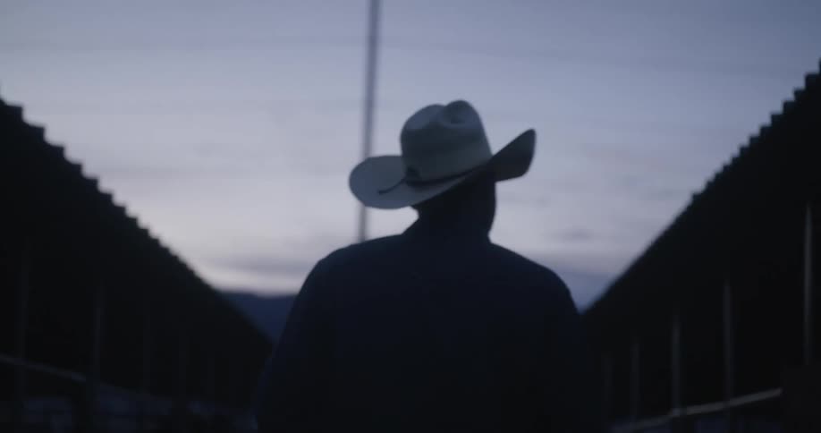 Man with his back walking on a ranch