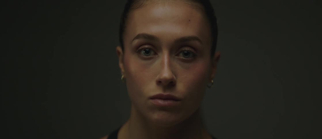 Portrait of a woman with light eyes in a dark environment
