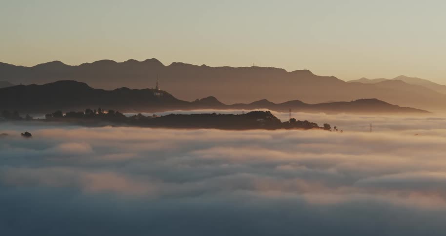Thick layer of clouds in between mountains