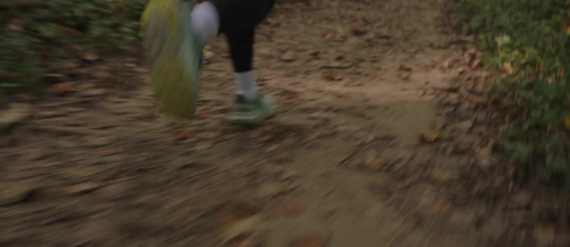 A person in running shoes exercising in the forest