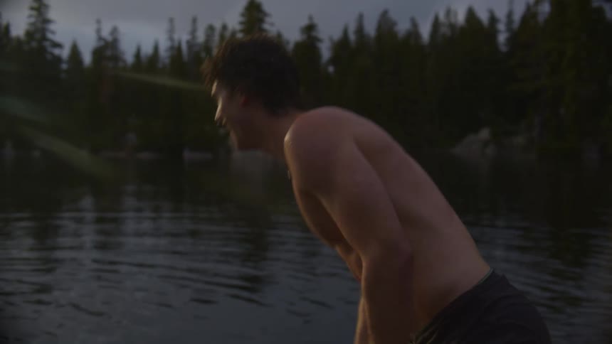 Man throwing an object into a lake