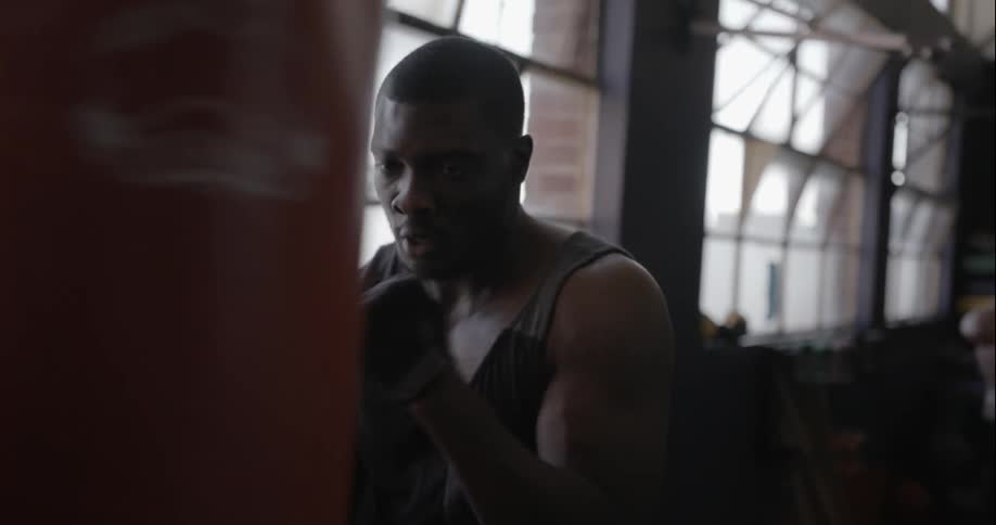 Man working out with a heavy bag