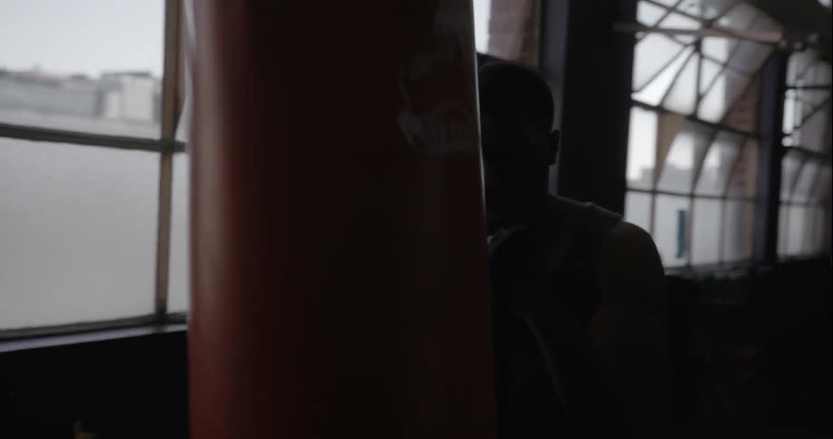 Man working out with a heavy bag