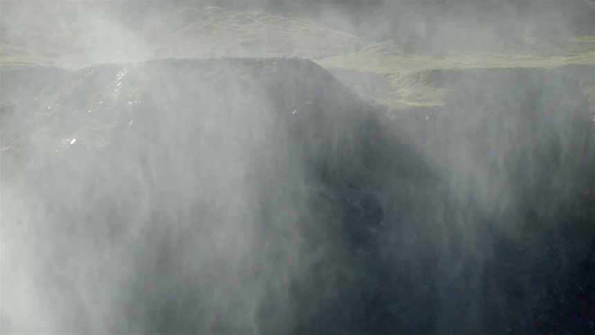 Steam billows over a mountainous landscape