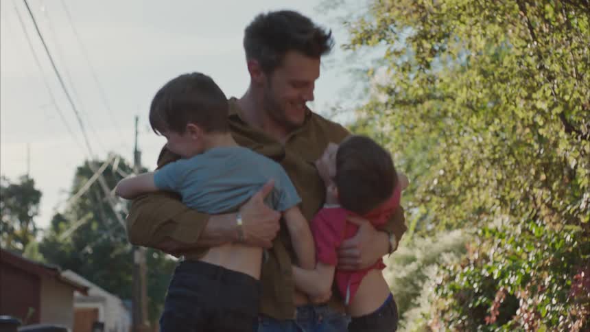 Children running to hug their father