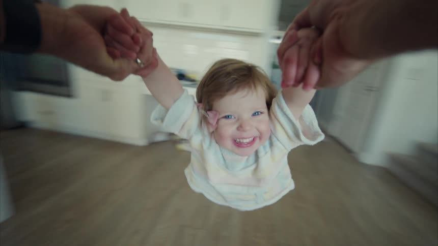 A father playing with his daughter in the room