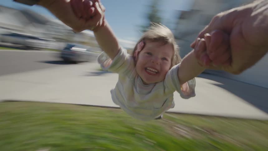 Someone is spinning a child in circle