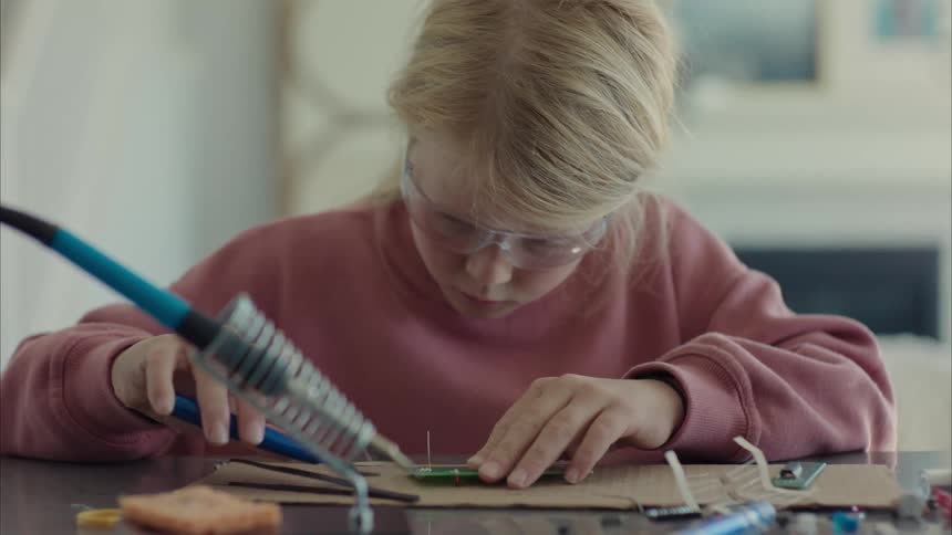 Girl soldering a small software board