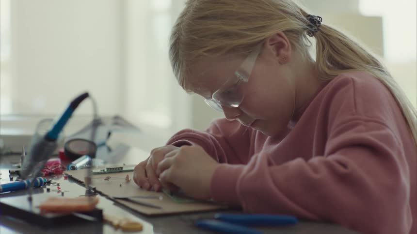 A child is repairing a computer chip