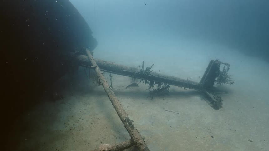 The mast of a sunken boat at the bottom of the sea