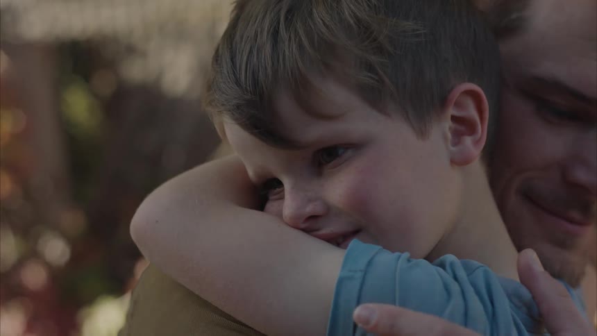 A clip of a father and son sharing a hug