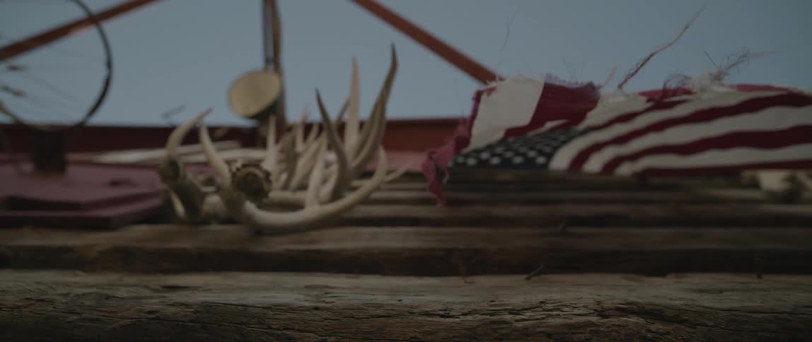 American flag waving on the wall of a barn