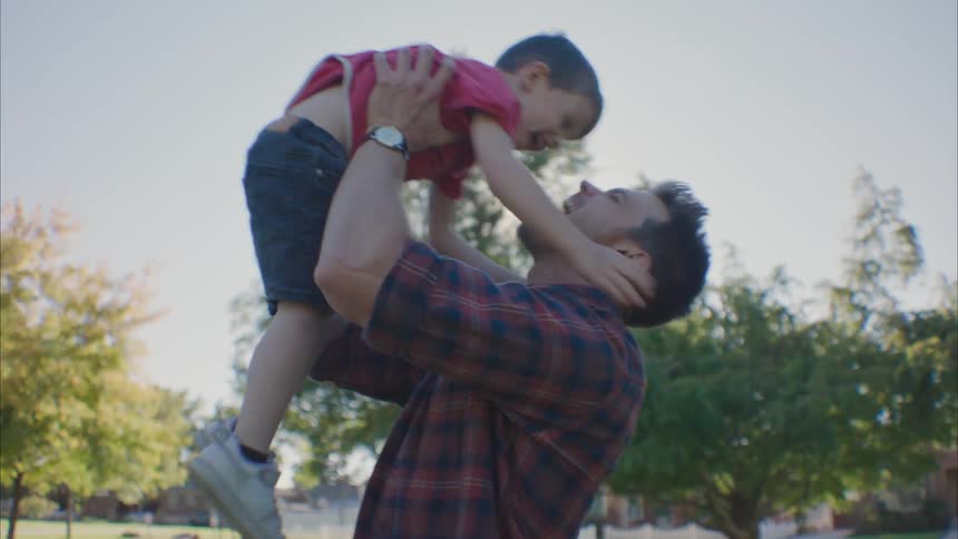 Son running towards his father who picks him up