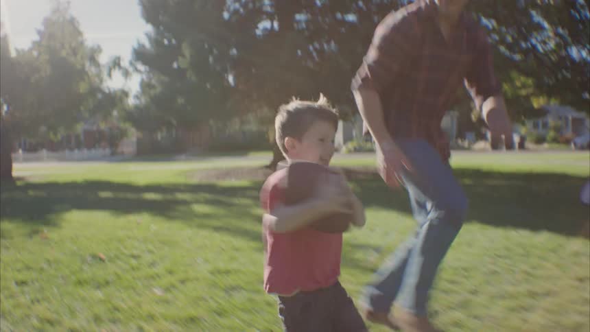 Father running after his son and picking him up